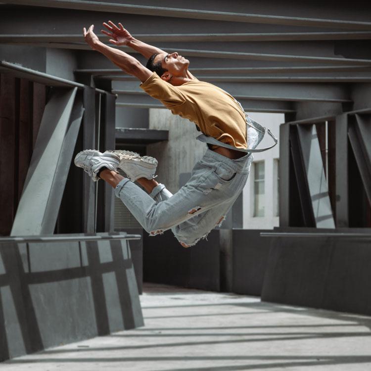 Man Dancing on Walkway